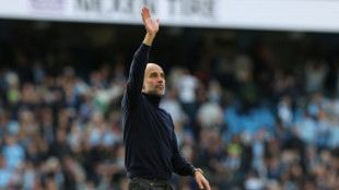 Guardiola warns title not won yet as Man City hunt down Arsenal