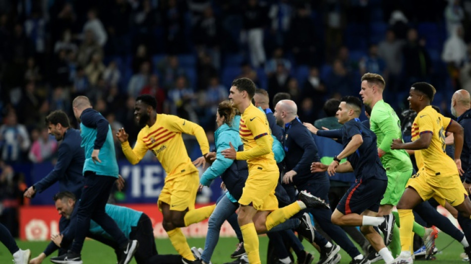 Triumphant Barca players chased from pitch by angry Espanyol fans